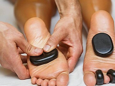Heavy Legs in Dubai Heat? How Hot Stone Massage Can Help